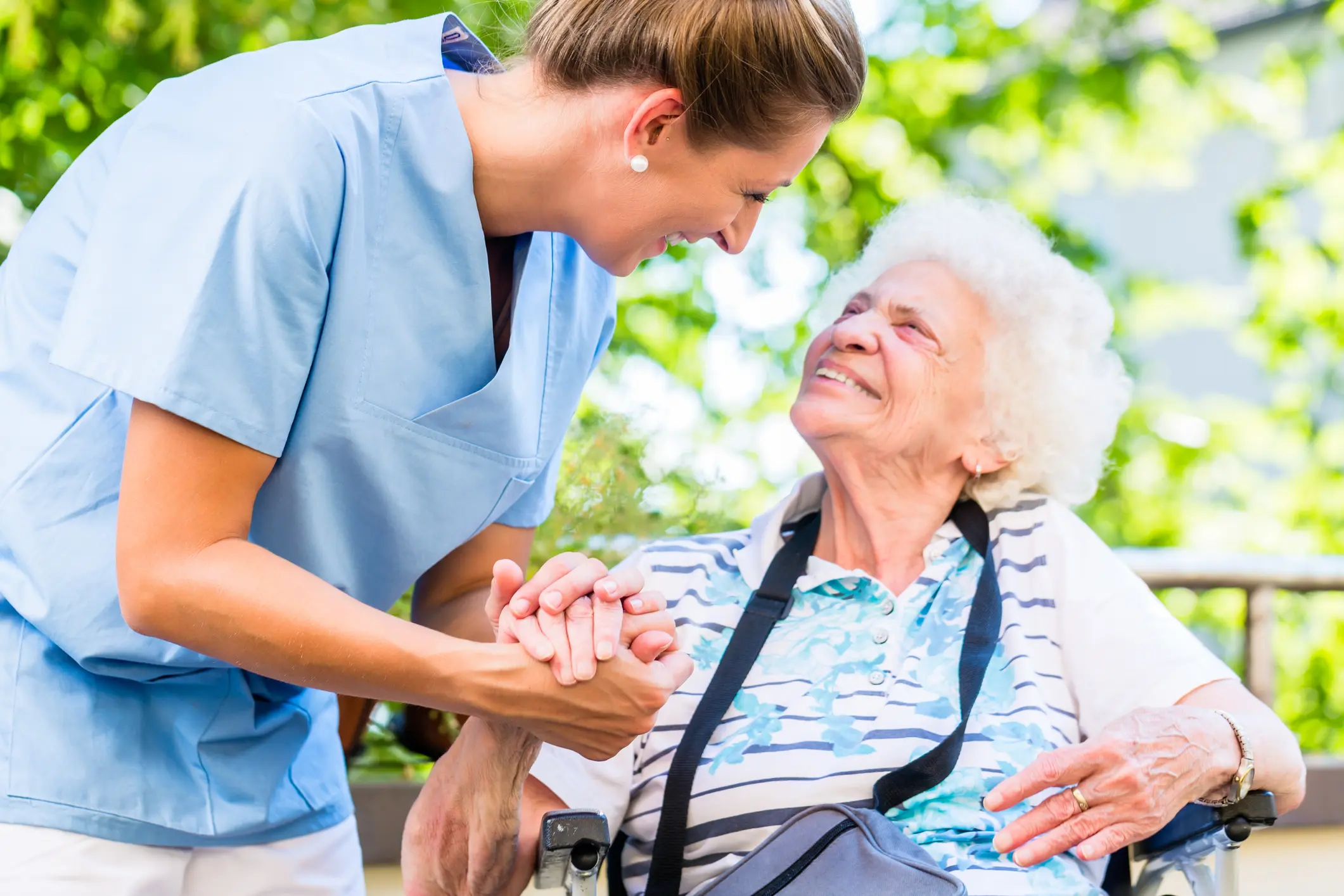 Home health care nurse assisting an older adult